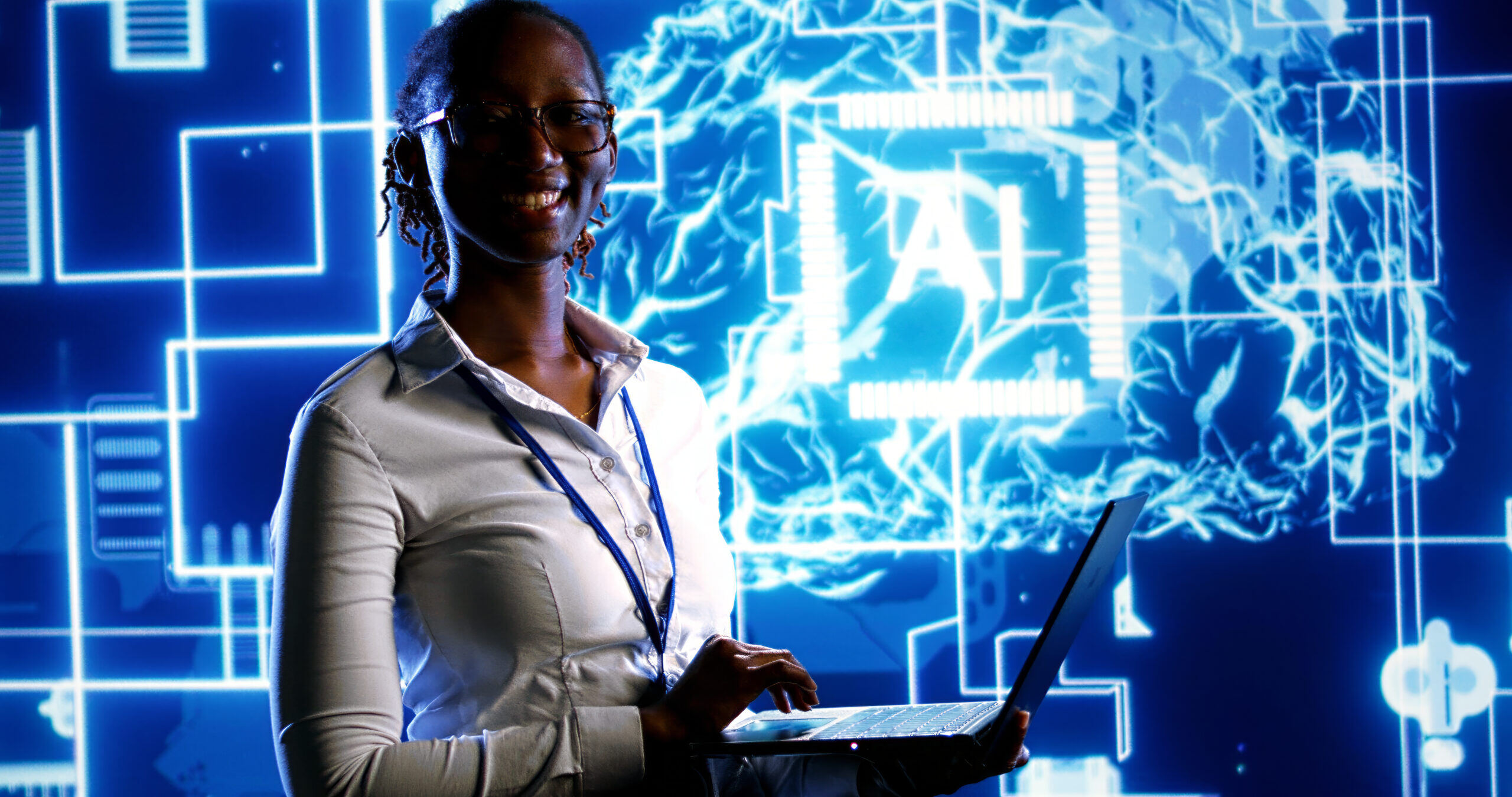 A person smiling while working on a laptop with a bright, futuristic AI graphic in the background.