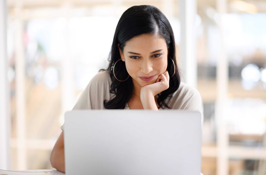 A woman looking at her emails on her computer.