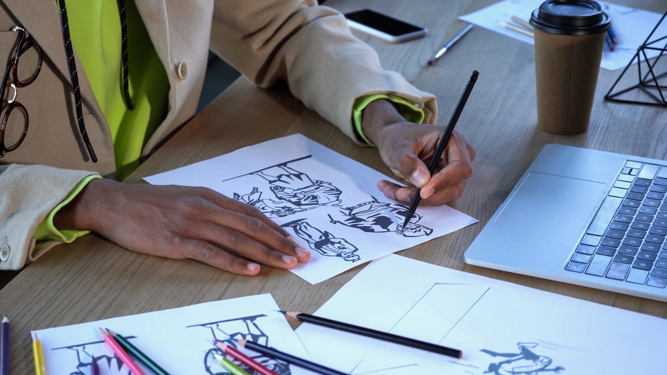 Graphic designer practicing his animations on a sheet of white paper and a pen