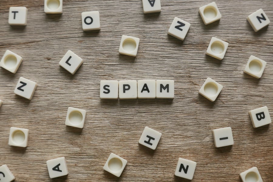 Board game tiles spelling out spam