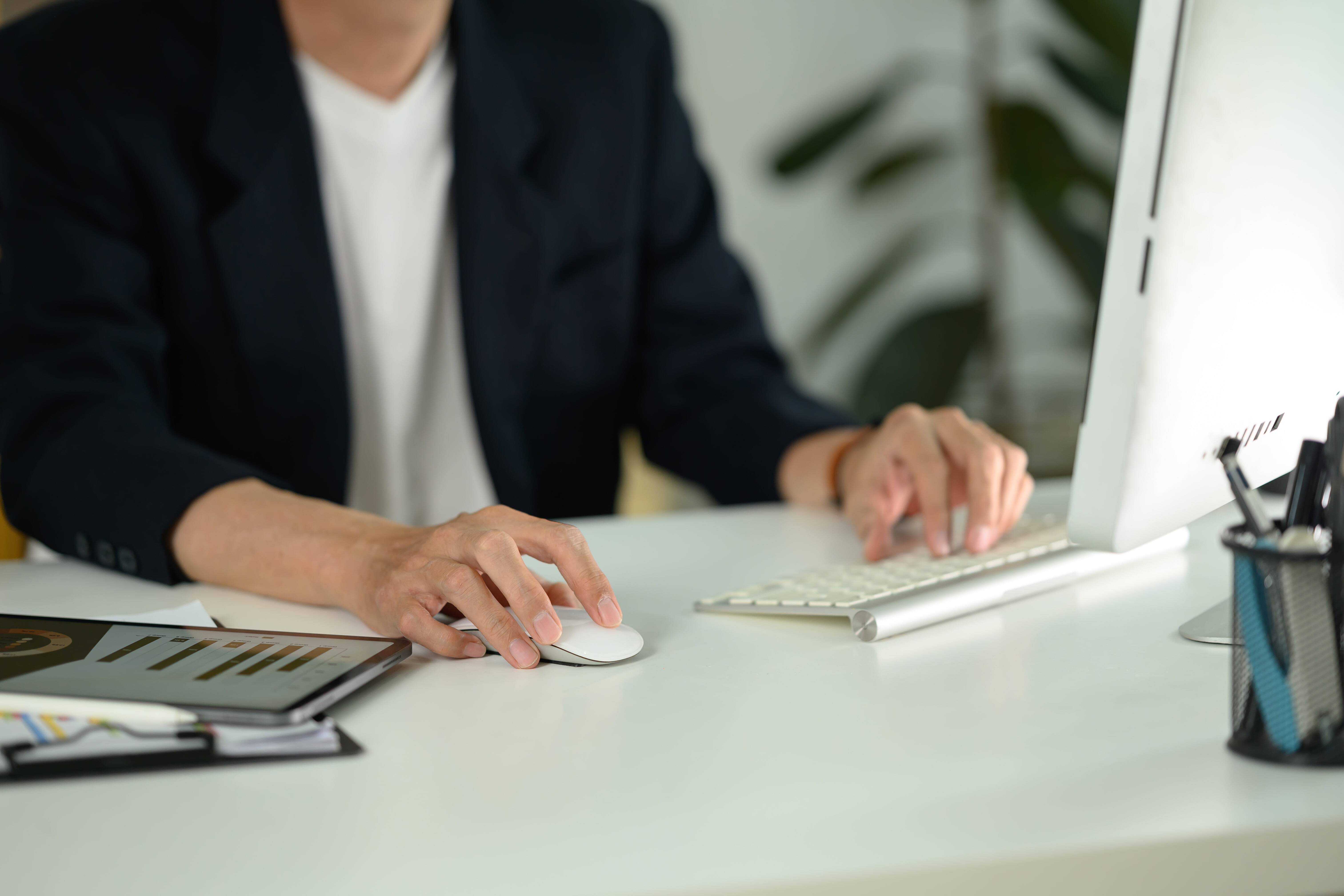 Man working on computer, putting UTMs into his marketing strategies-min