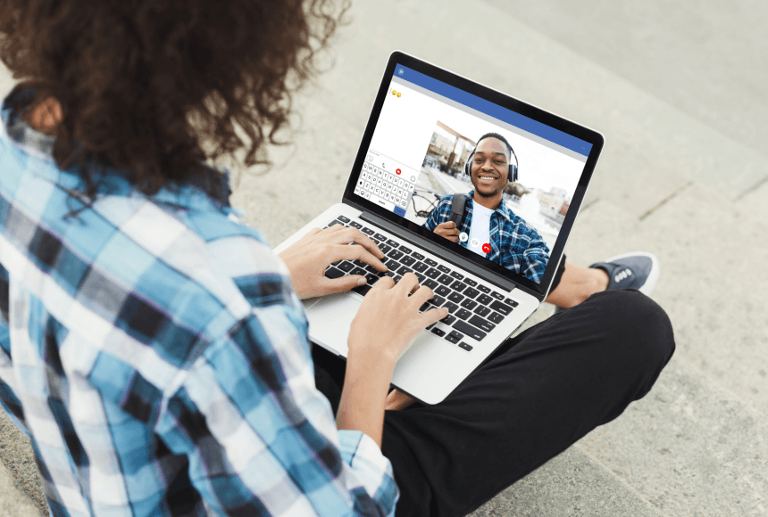 A woman in a blue shirt on a video call with a friend.