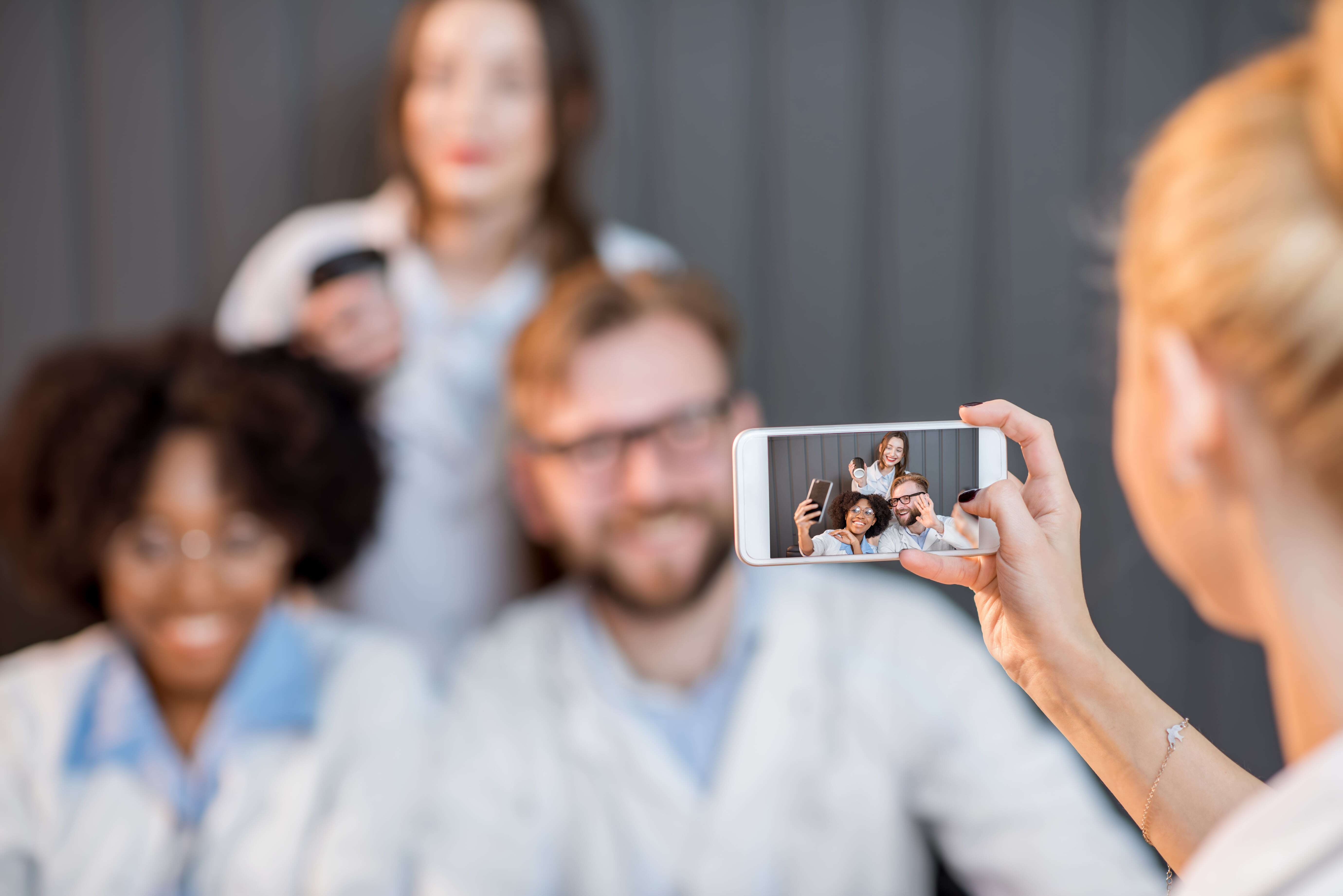 Medical device professionals posing for a photo to post on social media.&nbsp;
