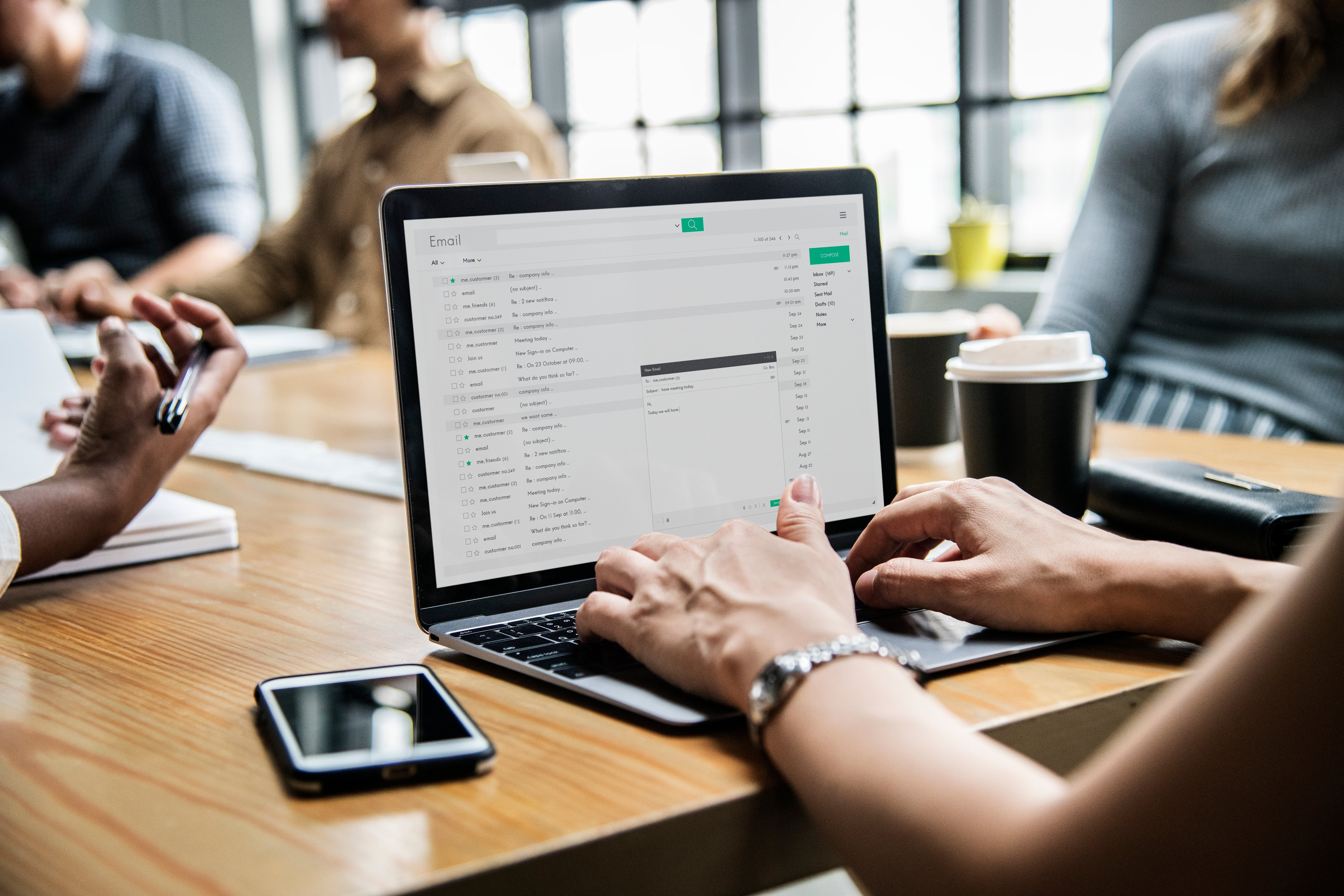 Woman checking her emails in a meeting-1